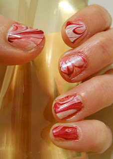 Close up fingers with red white nail polish