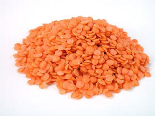 A pile of red lentils, also known as Masoor Malka or whole Masoor dal