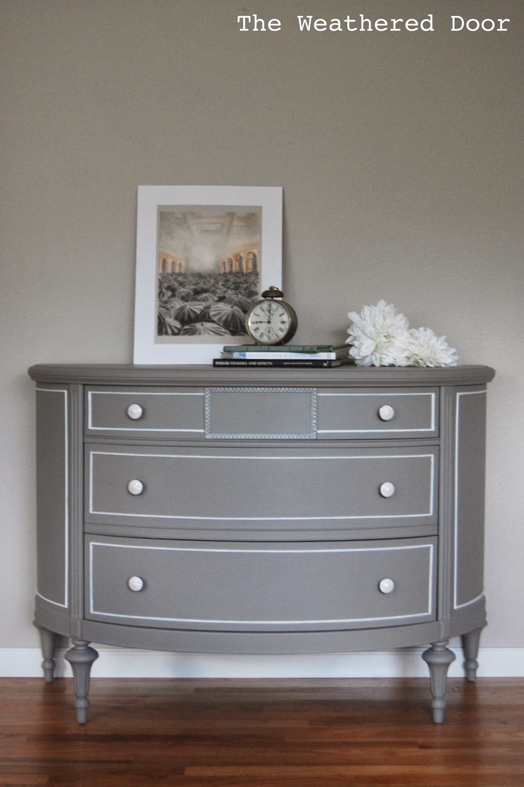 A grey demi lune dresser with white accents The Weathered Door