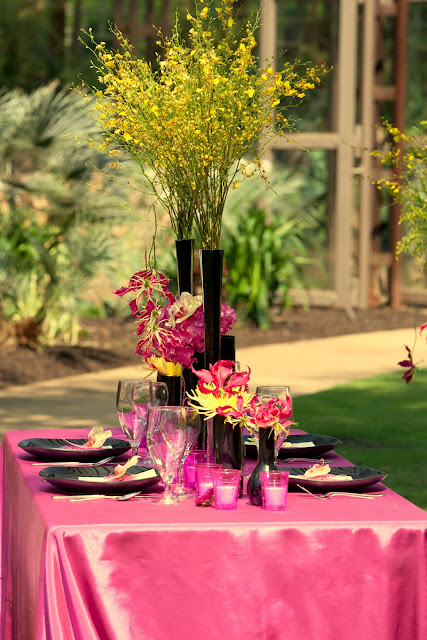 Tall narrow vases hold grouping of yellow oncidium orchids