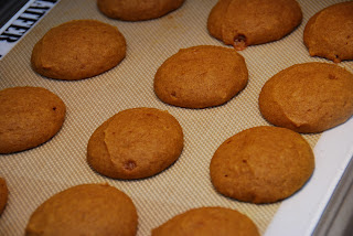 baked pumpkin sandwich cookie halves on baking mat