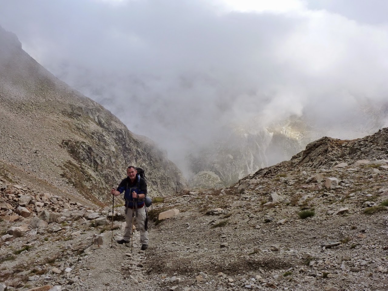 David on the steep rocky descent from the col