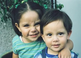 A little girl hugging her brother. A little girl hugging her brother.