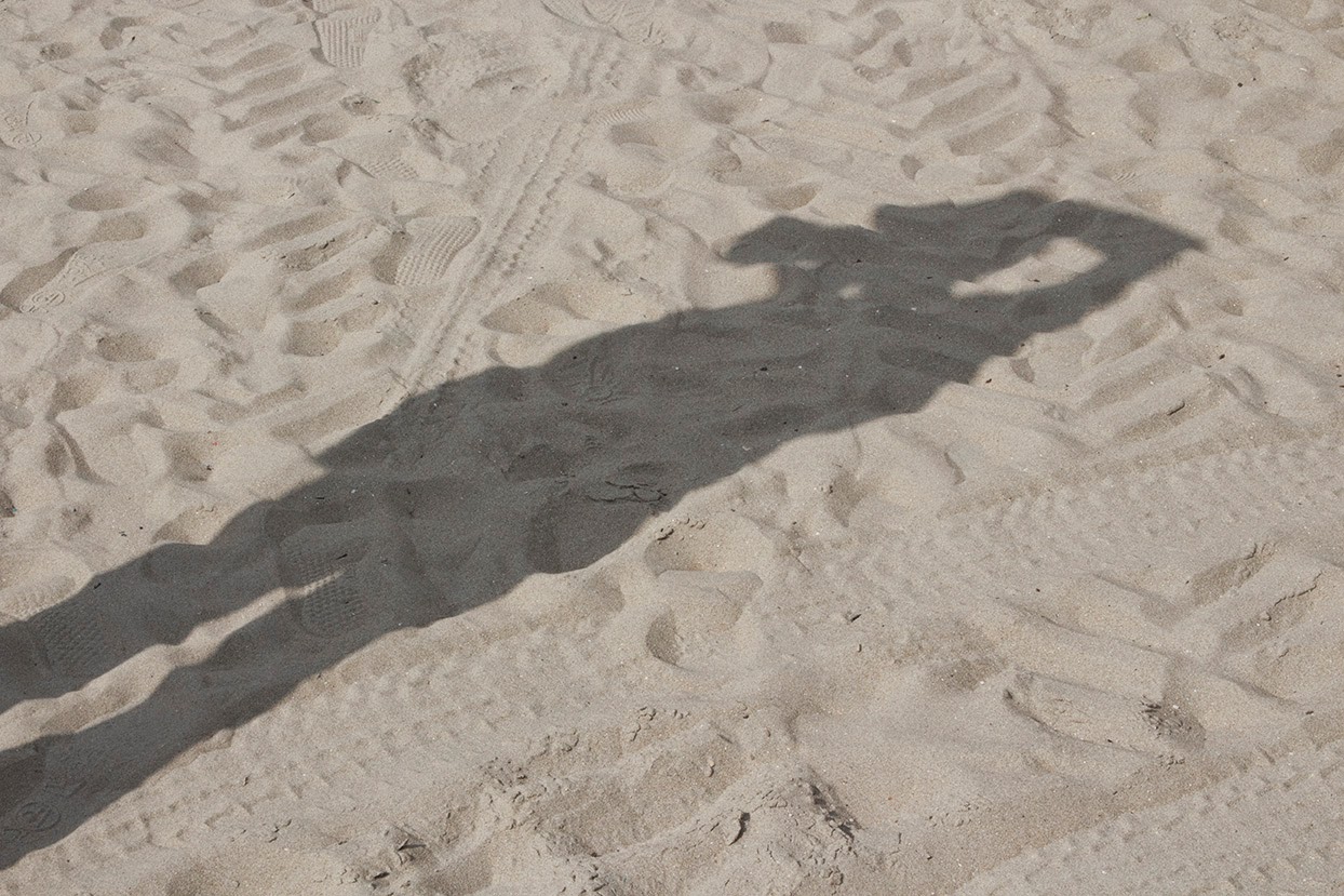 moment in sand with shadow