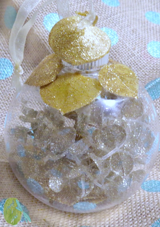 Ornament Exchange Tutorial finished project, Clear Plastic Ornament filled with Champagne and gold Glitter stems. 