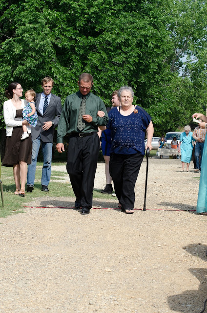 The bride's grandmother is escorted to her seat.