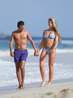 Amy Willerton and boufrienf holding hands on a sandy beach