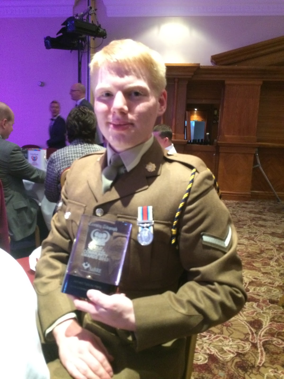 LCpl Hoskins of 159 Supply Regiment holding his award at the Pride of Coventry awards ceremony.