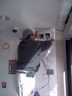 Operations Staff Working on the Wiring of the Door Openers Operations Staff Working on the Wiring of the Door Openers