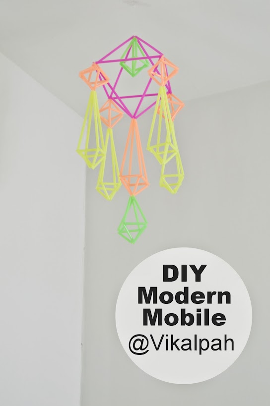A mobile made of straws hanging from the ceiling