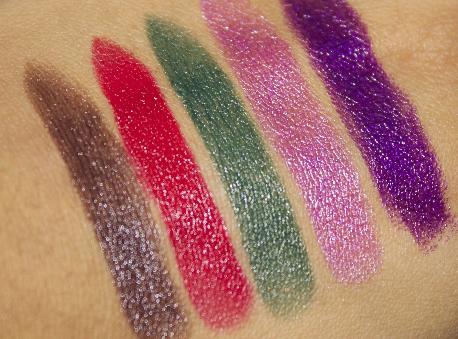 Makeup Revolution Atomic Lipsticks; Make Me Tonight, Ruby, Serpent, Make Me Magnificent, Make It Right A picture of hand swatches of the Makeup Revolution Atomic lipsticks