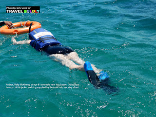 Travel Boldly Galapagos Island - Sally McKinney snorkels near Isla Lobos. A life jacket and ring supplied by the boat help her stay afloat. Photo credit Billy Giles.