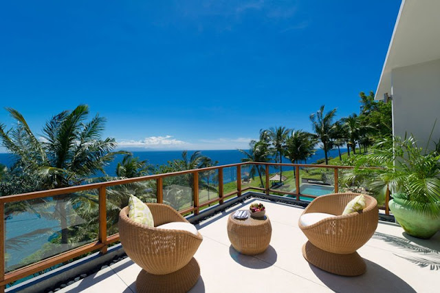 Picture of two brown chairs on the cliff villa terrace overlooking the ocean