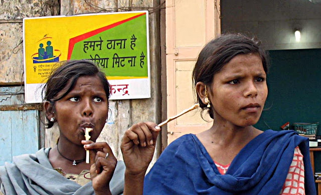 two young girls eating ice-cream on a stick