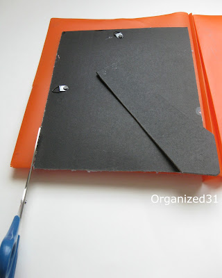 frame back on top of orange folder and scissors cutting