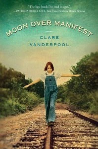 Cover of Moon over Manifest, girl in overalls balancing on a train rail