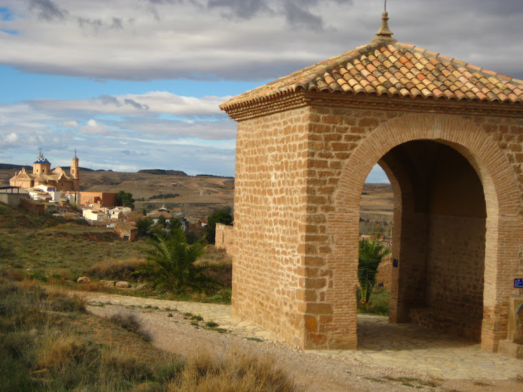 Arco del descanso y el pueblo al fondo.