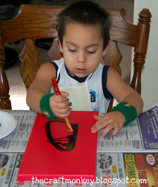Little boy painting a canvas