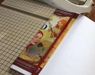 book being trimmed on paper cutter