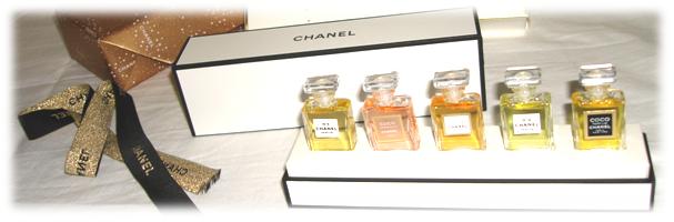 A photo of the Chanel wardrobe, with five miniatures, from left to right: Chanel No.5, Coco Mademoiselle, Allure, No.19 and Coco, all in Parfum strength.