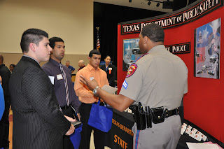 Students talk to a trooper from the Texas Department of Public Safety at the 2011 Career Fair.