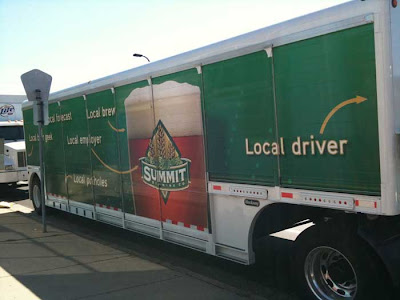 Green Summit Brewing truck with labels on the side, such as Local Driver, pointing at the cab