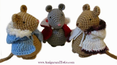 three crochet mice with crochet capes on