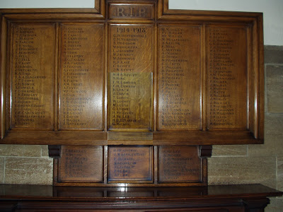 A wooden board bearing 160 names in five main panels with a smaller board below as if added later.  The top of the board reads RIP 1914-1918
