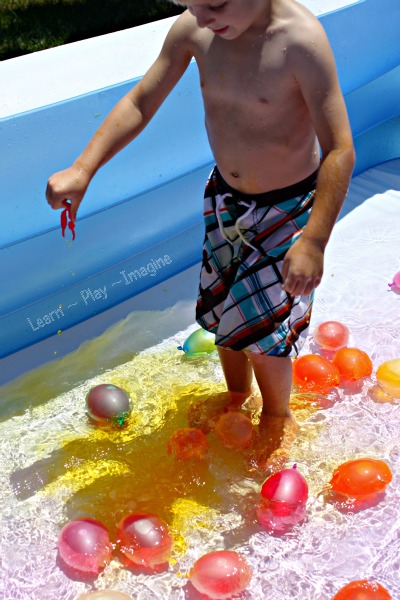 Exploring color theory in the play pool with water balloons filled with colored water
