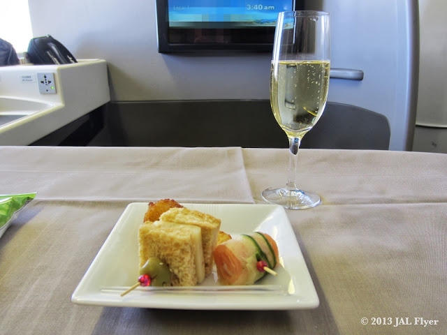 JAL First Class trip report on JL005: Starter served with a glass of Champagne SALON 1999.