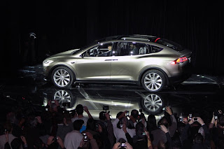 Tesla with a model of type X Tesla with a model of type X