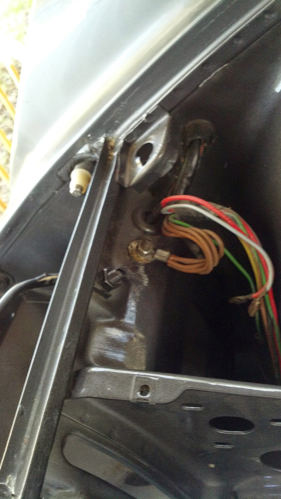 Mount the grounding harness and the headlight motor ground wire (not shown yet) to the stud.