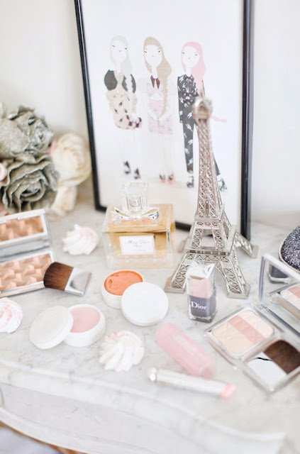 make-up supplies, perfume and mini Eiffel-tower on a dressing table