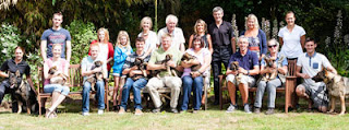 A group photo of the new walkers with their puppies sat in the garden