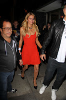 Paris Hilton looks hot in  short orange dress