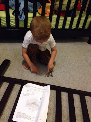 toddler helping build bed