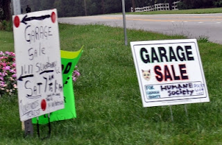 Garage Sale Signs at Entrance of Development