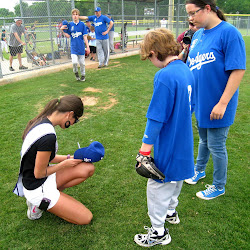 Signing a hat for a Miracle League Player