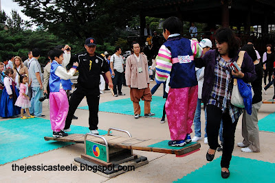 Korean boys trying out 널뛰기 (Nol Ttwigi), a traditional seesaw game for Chuseok actvivities at Gyeongbukgong Palace, Seoul