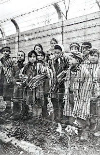 Nazi concentration camp: Auschwitz children behind barbed wire fences Nazi concentration camp: Auschwitz children behind barbed wire fences