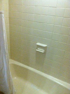 a white bathtub with a white shower curtain