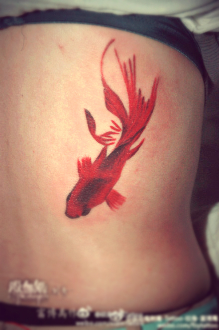 red goldfish tattoo on the hip