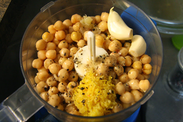 Drained chickpeas, lemon juice, lemon zest, garlic cloves, salt & pepper, olive oil in a food processor for hummus (humus).