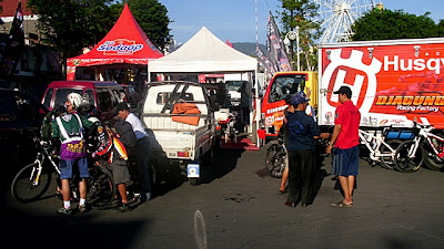 Menurunkan sepeda dari pick-up di depan Alun-alun Batu.