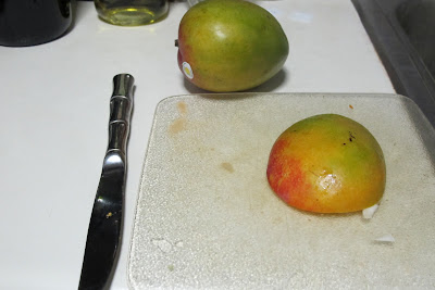 Cut a near half of the mango outside the pit