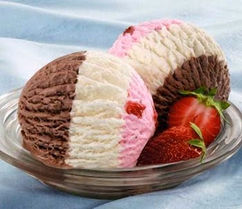 neapolitan ice cream served in a bowl with a strawberry