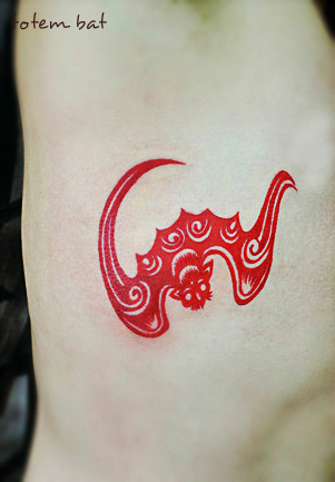 a unique red totem bat tattoo