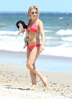 Julianne Hough holding her dog at the beach