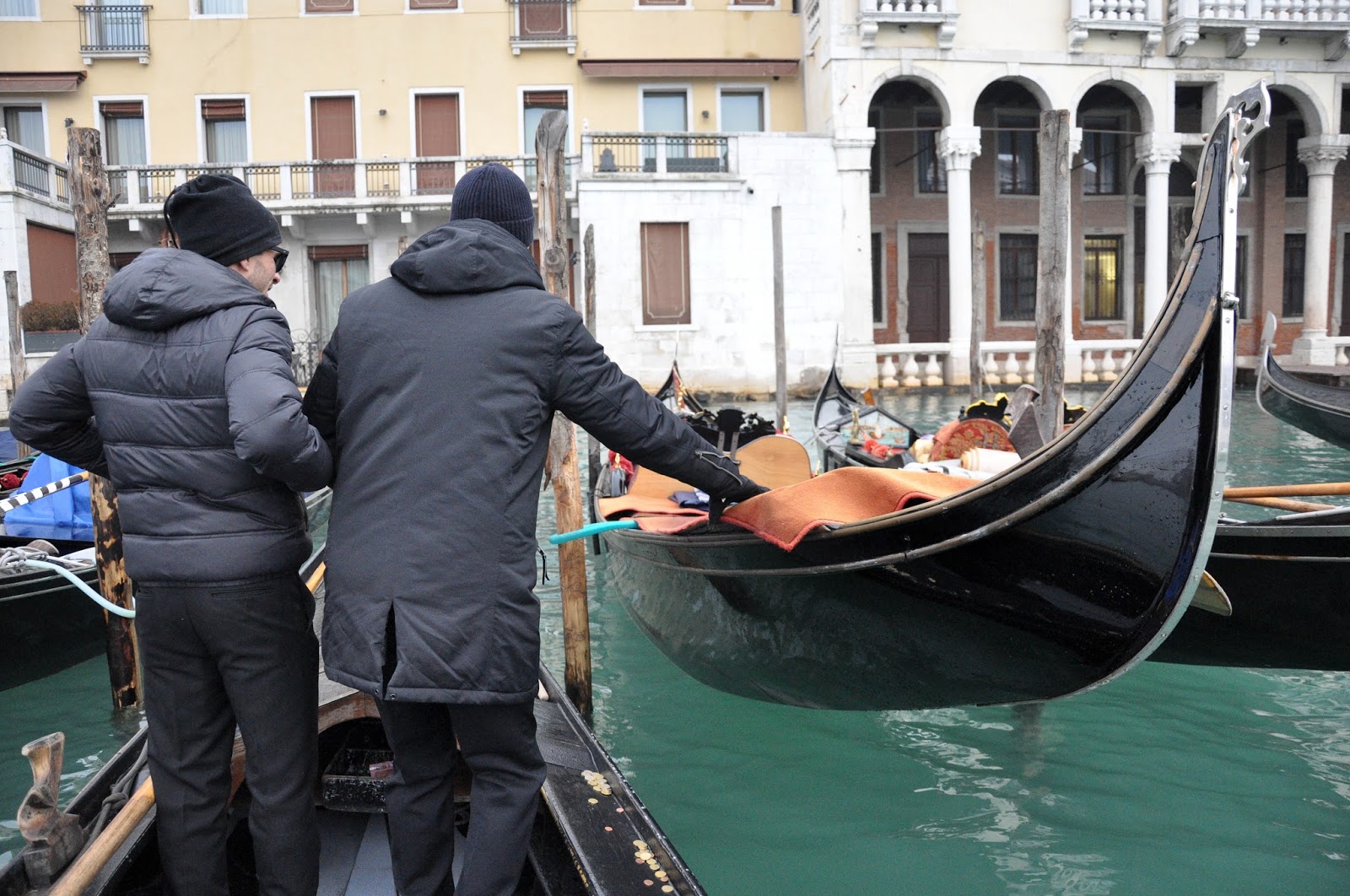 A gondolier gets on his gondola from a traghetto, Venice, Italy