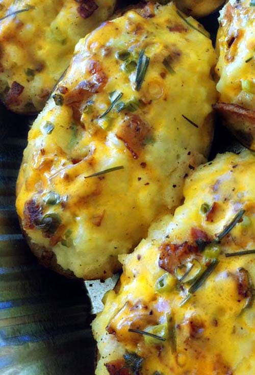 Loaded Twice Baked Potatoes with sharp cheddar, bacon and green onions.